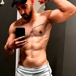 Fit and Muscular Bodybuilder Captures Selfie in Gym Mirror