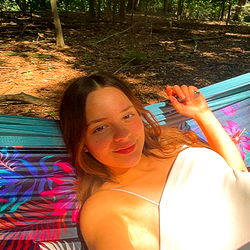 Lola lounging in a hammock in the park