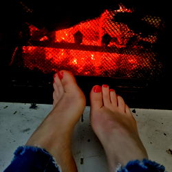Cozy Moment with Feet in Fireplace