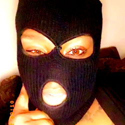 Melons Monroe, a model posing in a balaclava with a mask on her eyes