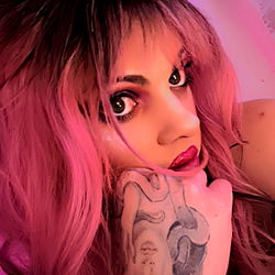 Odessa Vollan, a model with pink hair and tattoos