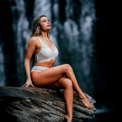 Vogue Model Sitting on Rock