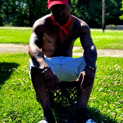 A young man poses casually for the camera in a relaxed setting.