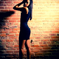 BettyNextdoor poses confidently against brick wall