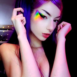 OnlyFans Model Dani Showcasing Vivid, Multi-Colored Makeup on a Daringly Neon Setbackdrop