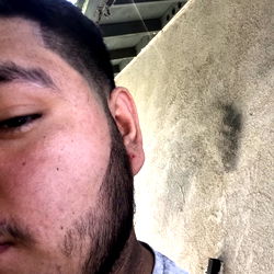 Jose Arroyo, a young adult man with a beard and short hair, showing a profile view.