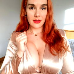 Red-headed At home model Ainoa in a sleek golden dress