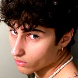 Gene, a Tattooed North American Model Striking a Thoughtful Pose