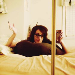 An individual enjoying a moment of tranquility in their room