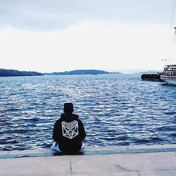 Contemplative Silhouette of Man on Pier