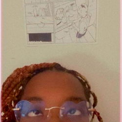 A person sitting in front of a colorful poster,