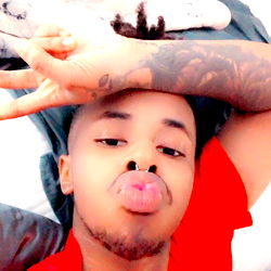 Zell in a Red Shirt Posing on Bed