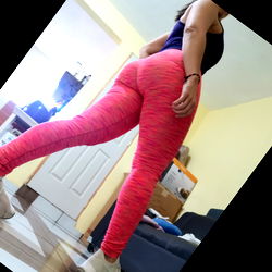 Fitness model posing for camera in vibrant leggings