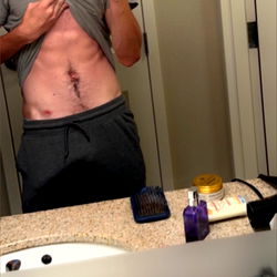 Fit Model Showcasing Abs in Bathroom Mirror