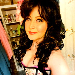 Vintage-Style Cosplay Enthusiast with Pink Flower Hairpiece