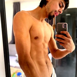 A Fitness Enthusiast's Shared Selfie with Phone and Shirt On