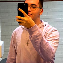 AleCG - Young Man in a Purple Shirt with Short Hair Taking Selfie