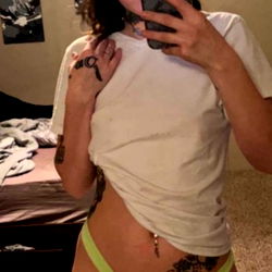 Alecia, An OnlyFans Model Showcasing Her Tattooed Body and Bikini-Like Attire