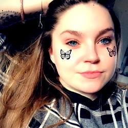 Georgia Dee, a young adult model with butterfly makeup accents,