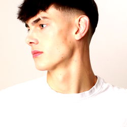 Stylish Young Man with Short Hair, Black T-Shirt and Tattoo on Right Arm