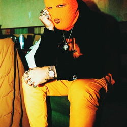 Solo Artist in Orange Mask and Tie-Dye Shirt