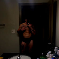 A fitness-focused model in bathroom mirror