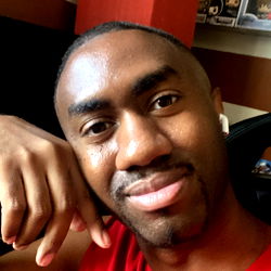 Caucasian man with a beard and glasses, posing