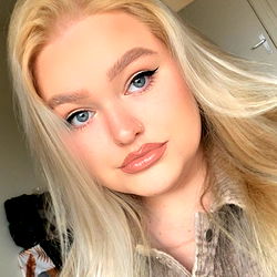 A Blonde Female With Light Makeup