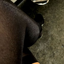 Riah, a model in thigh-high stockings posing at a car dealership