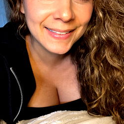 Smiling Woman with Long Hair and Zippered Jacket