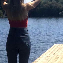 Stylish Ivy Rose Standing by a Lake