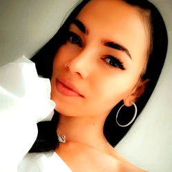 Anna with a confident smile poses for her OnlyFans profile