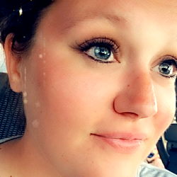 Sweetaspie09, a 27 year old female with striking blue eyes and a friendly smile poses for the camera. Her gaze is gentle and inviting.