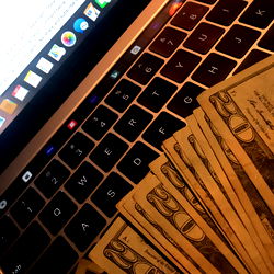 Financial Influencer's Workspace with $10,00 Cash on the Table