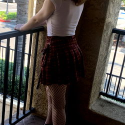 Ashley Harris, a model standing on a balcony.