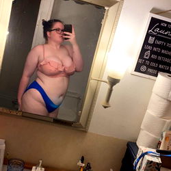 A Model Taking a Mirror Selfie in a Bathroom