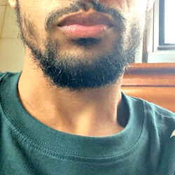 Man with beard and mustache in blue t-shirt