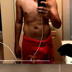 Fitness enthusiast in a mirror reflection capturing his progress