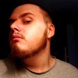 Bearded Man with Tattoo in Background, Contemplative Expression