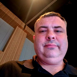 A man in a black polo shirt