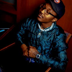 Kozy in a relaxed pose with sunglasses