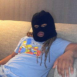 Person in a mask resting on a couch