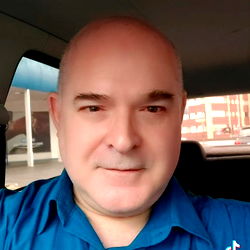 Anselmo Lopes, a Professional Man in a Blue Shirt and Dark Glasses