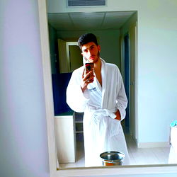 Young Man in a Bathrobe Taking Selfie