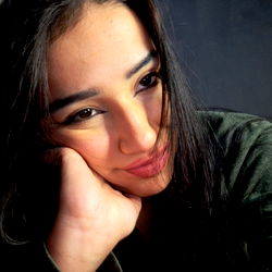 A woman posing for the camera with a thoughtful expression.