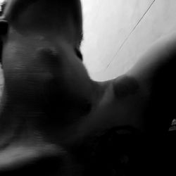 A captivating snapshot of OnlyFans model Dexter in a black and white photograph, set against a stark white wall.