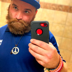 A Bearded Man in a Uniform Taking a Selfie