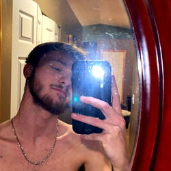 Shirtless Man with Tattoo Taking a Selfie in the Mirror