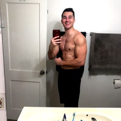 Muscular Man in Bathroom Mirror