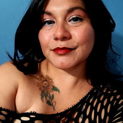 Atena, an OnlyFans model from Texas, poses for a photo with a confident and sensual expression.